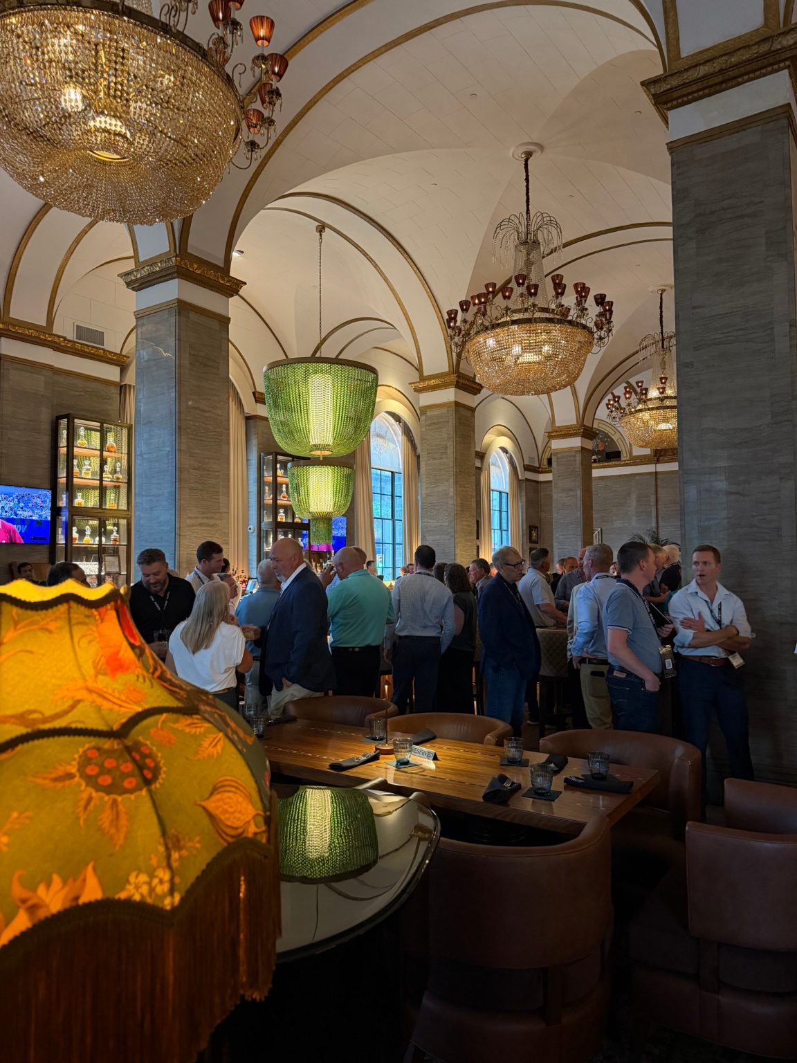 AVS attendees under the chandeliers at the Hotel Cleveland lobby bar