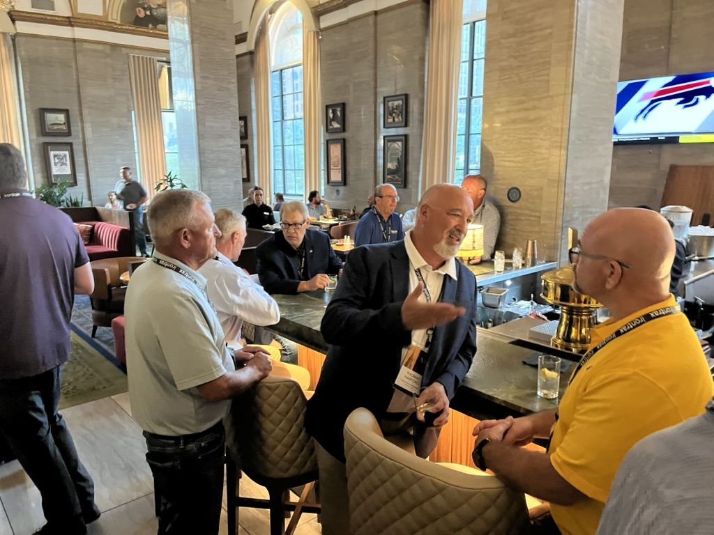 Attendees talking at the bar